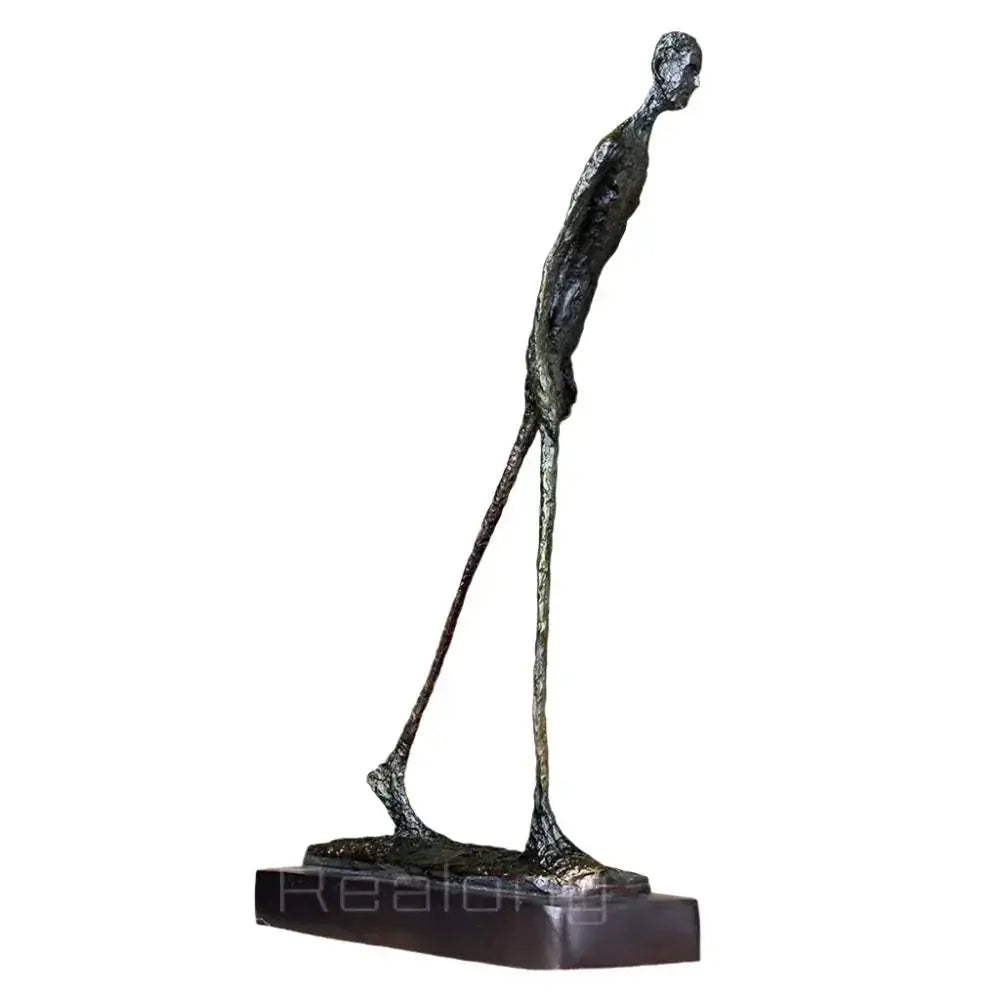 Abstract walking man sculpture bronze with textured surface slender elongated figure on dark rectangular base