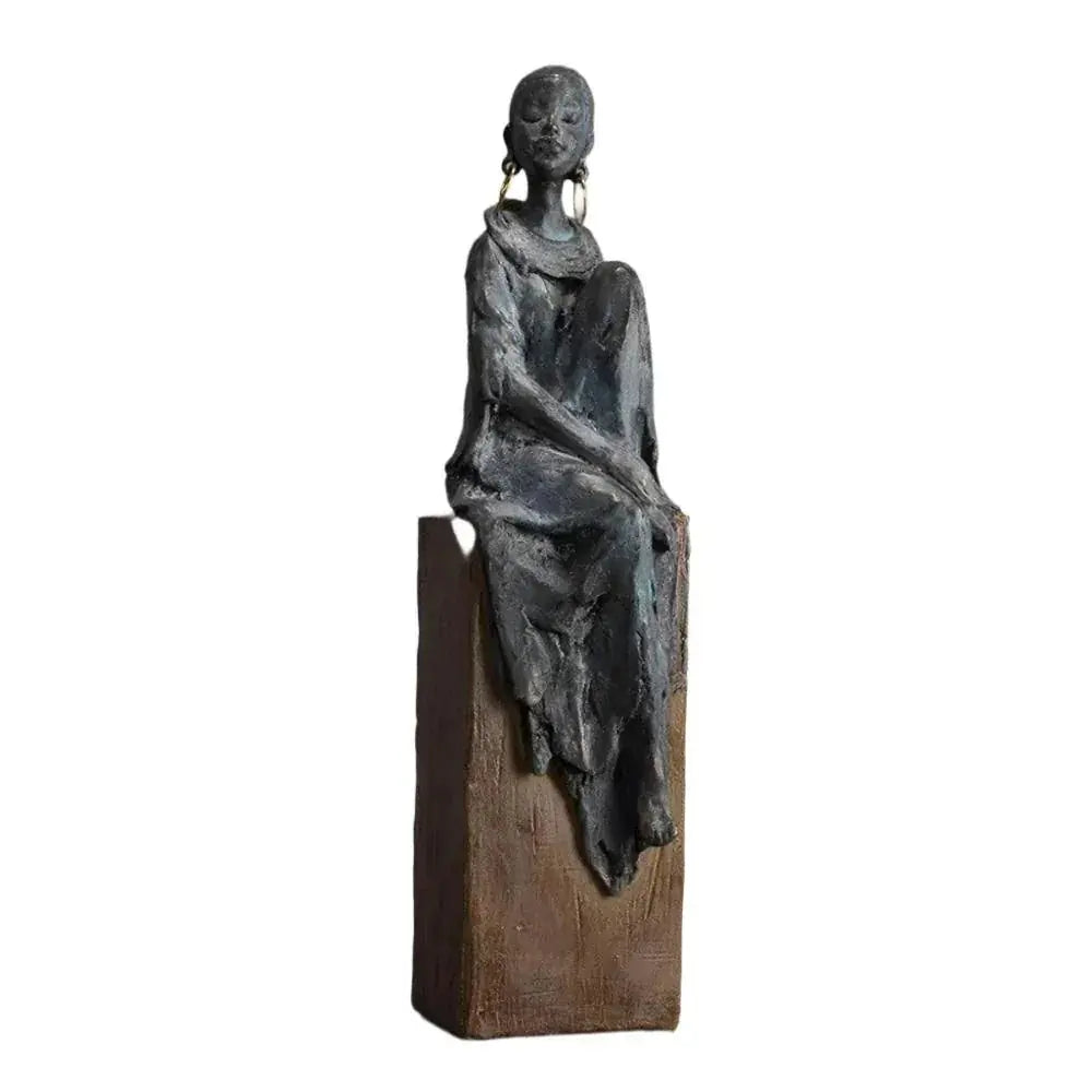 Bronze-colored african women sculpture figurine of seated woman with draped fabric and hoop earrings on wooden base