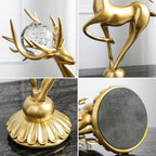 Golden deer figurine with crystal floral accents holding a clear glass orb on an ornate fluted base