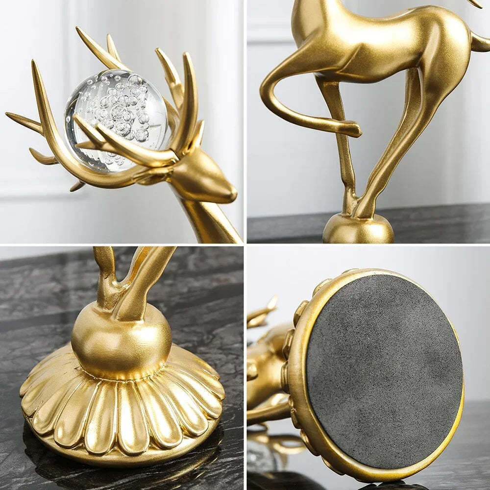 Golden deer figurine with crystal floral accents holding a clear glass orb on an ornate fluted base