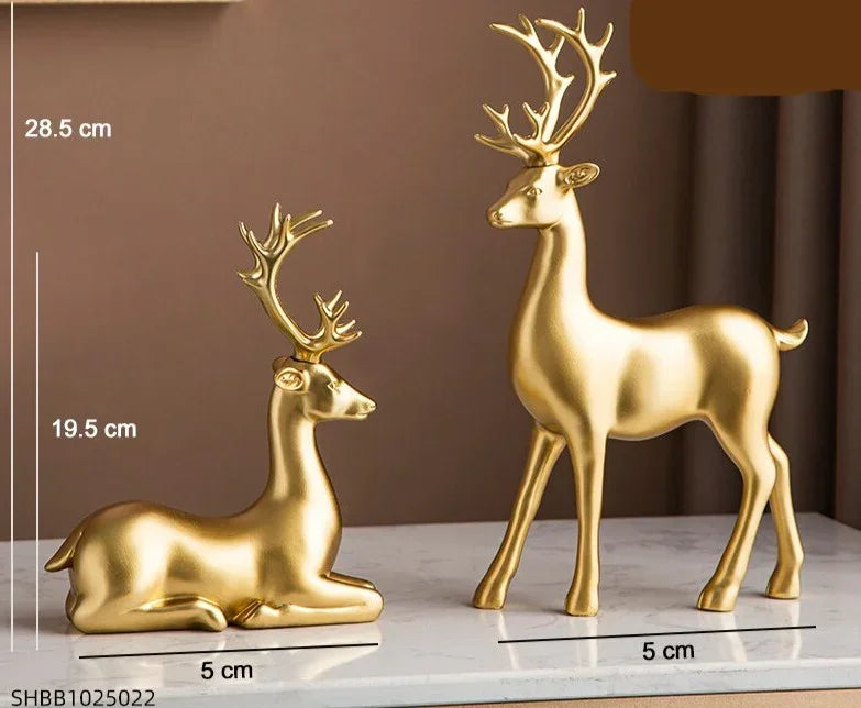Golden resin deer figurine set with one standing and one reclining featuring detailed antlers and crystal floral accents