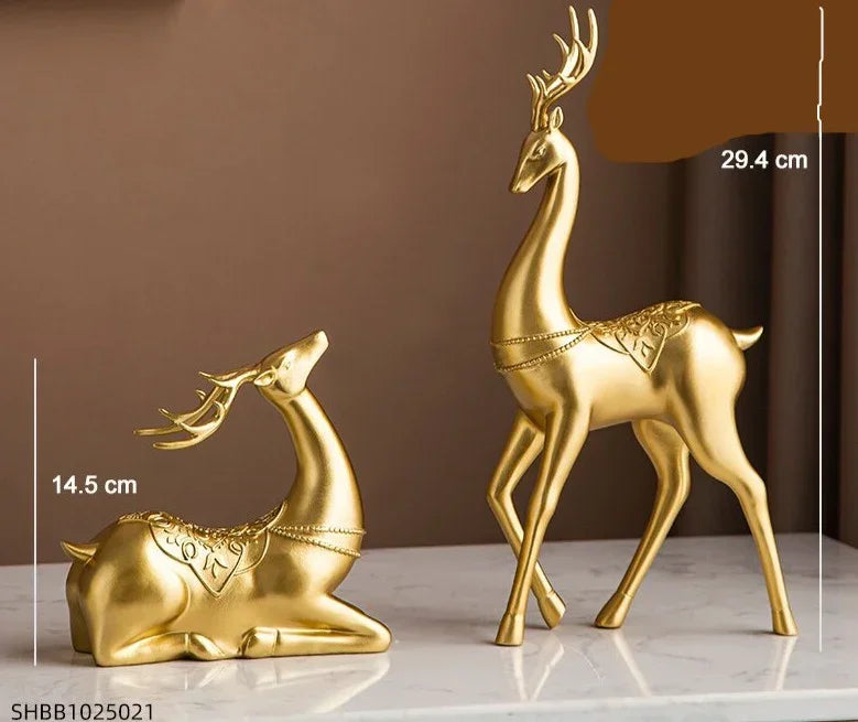 Golden resin deer figurine set featuring one standing and one reclining deer with intricate crystal floral accents