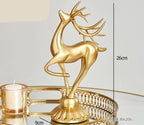 Golden deer figurine with intricate antlers and crystal floral accents in a sleek, stylized design