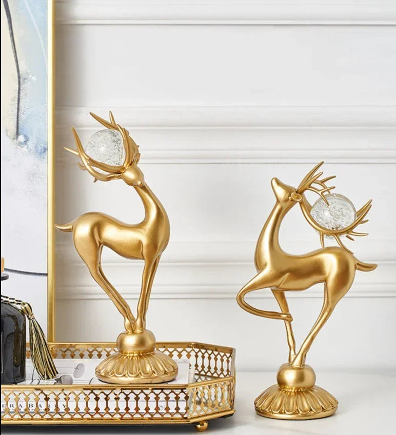 Golden deer figurine set with crystal floral accents featuring crystal orbs in antlers on ornate golden bases