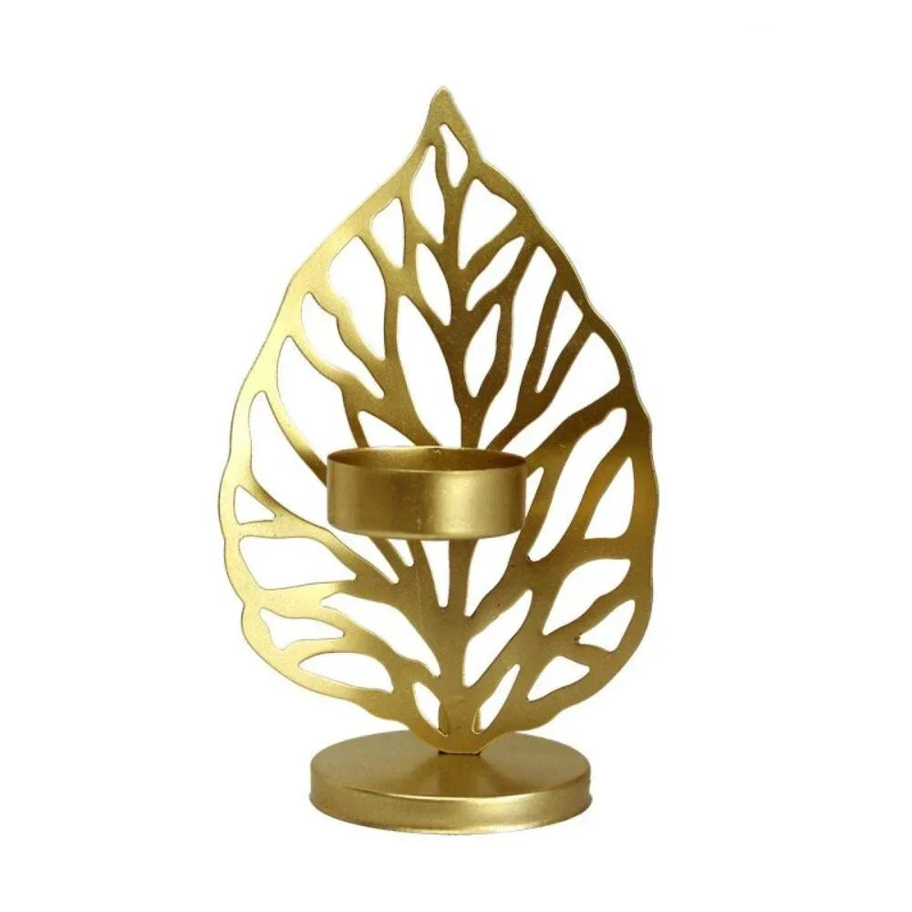 Gold leaf metal candle holder with intricate cutout veins and circular tealight cup for decorative use