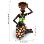 Tribal candle holder featuring an african-inspired resin tribal lady figurine kneeling with gold jewelry and green top