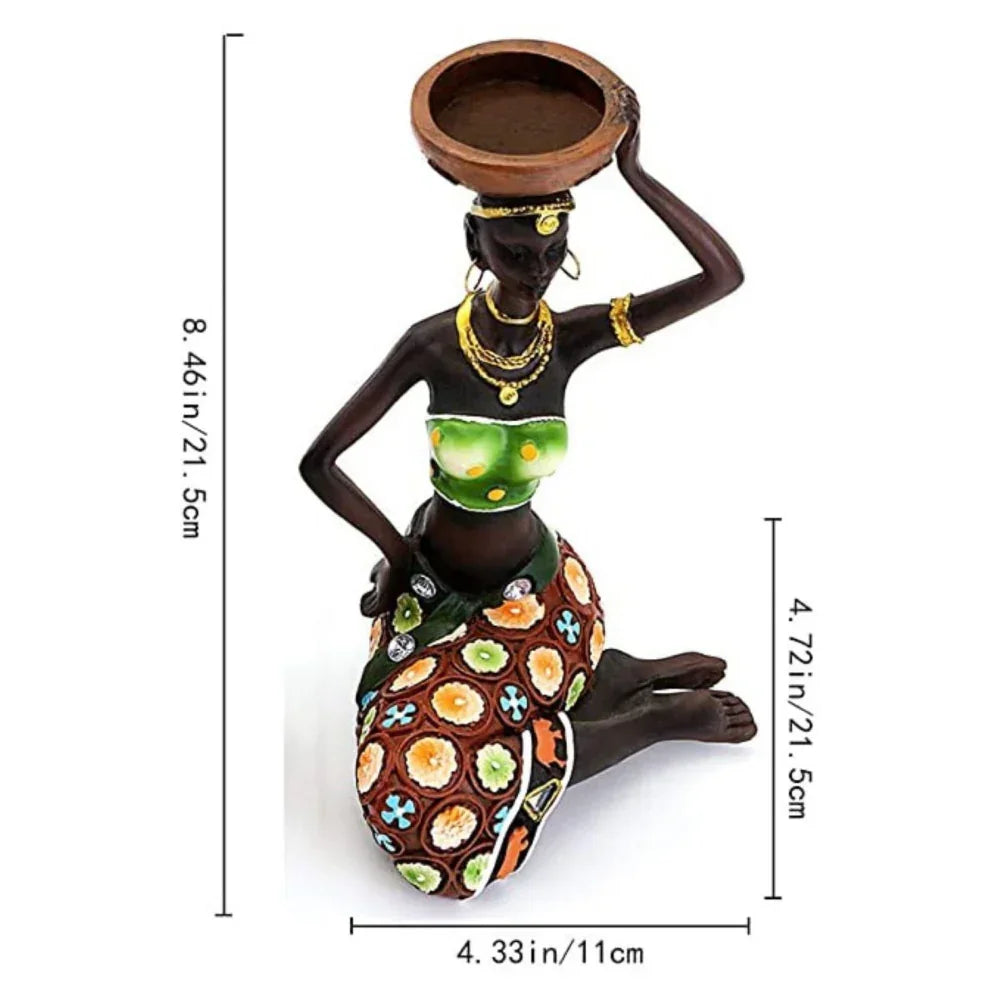 Tribal candle holder featuring an african-inspired resin tribal lady figurine kneeling with gold jewelry and green top