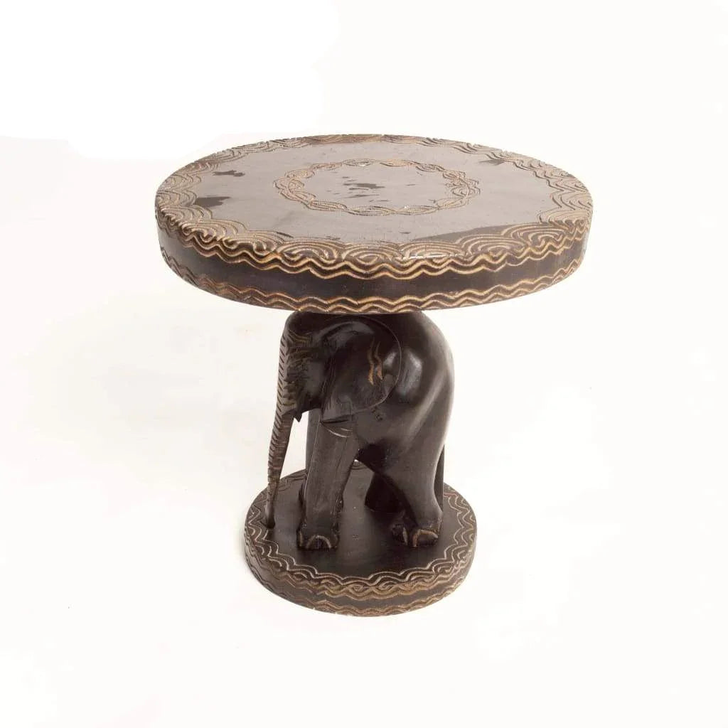 African hand-carved wooden side table with an elephant base and decorative patterns