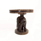 African hand-carved wooden side table with an elephant base and decorated round top