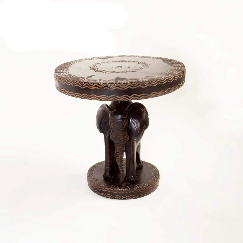 Hand-carved African wooden side table with elephant base and decorative patterns