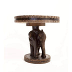 African hand-carved wooden side table featuring a detailed elephant sculpture base with decorative patterns
