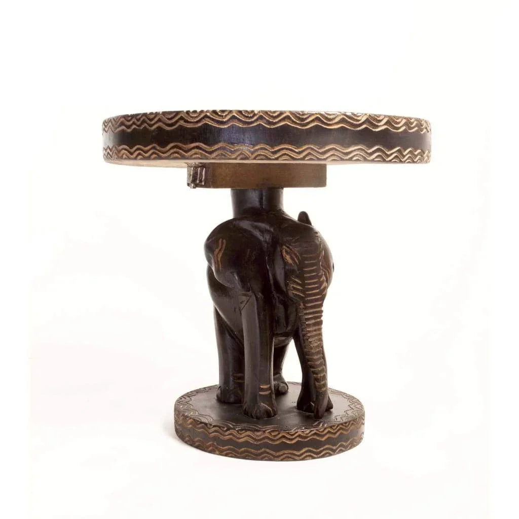 African hand-carved wooden side table featuring a detailed elephant sculpture base with decorative patterns
