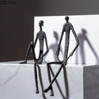 Black wrought iron sitting man figure, modern abstract metal art - House of Avana